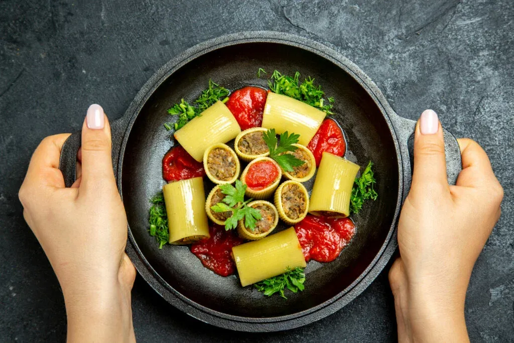 top-view-raw-italian-pasta-with-meat-greens-tomato-sauce-inside-pan-dark-grey-background-pasta-dough-meal-food-1024x683-1.webp