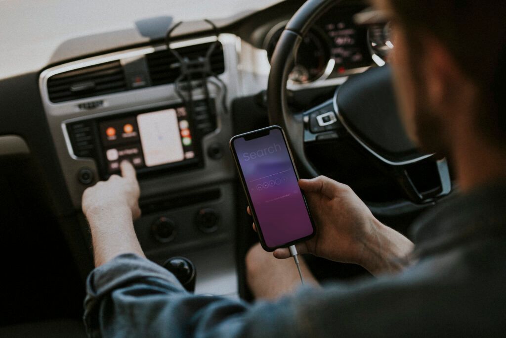 driver-using-mobile-phone-searching-information-1024x683.jpg
