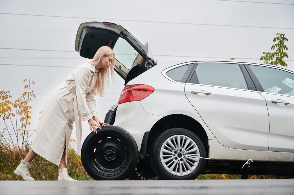 stopped-white-car-with-punctured-car-tire-roadside-1024x679.jpg