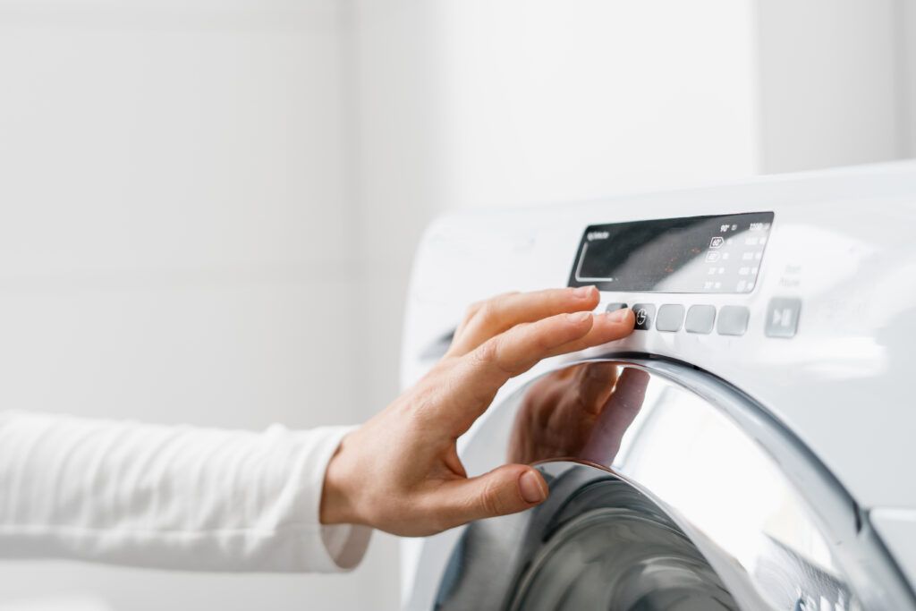 female-hand-press-button-washing-machine-indoors-1-1024x683.jpg