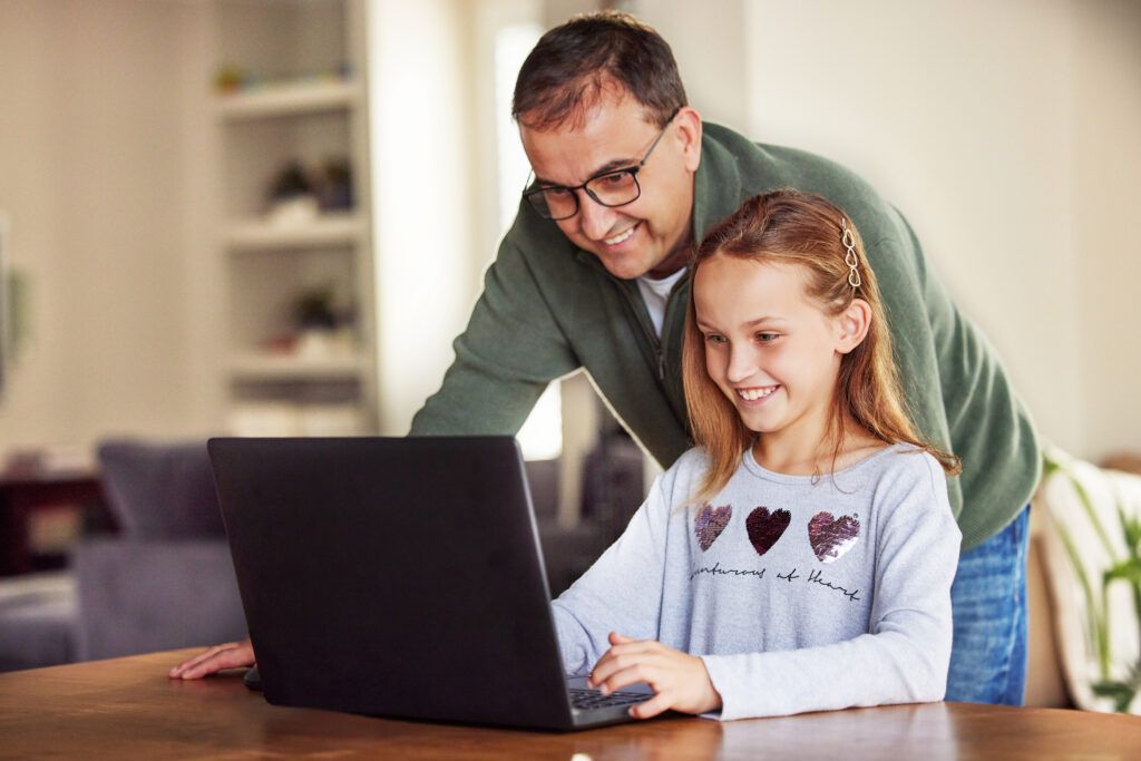 dad-come-see-this-shot-adorable-little-girl-sitting-using-laptop-home-while-her-father-helps-her-1024x683.jpg