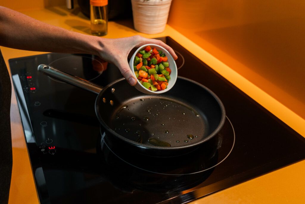 unrecognizable-person-throwing-vegetables-frying-pan-1024x683.jpg