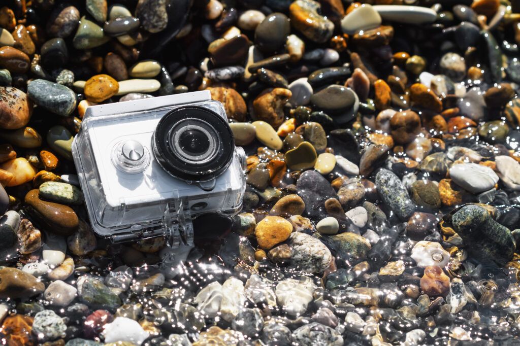 white-action-camera-with-underwater-case-pebble-beach-1024x682.jpg