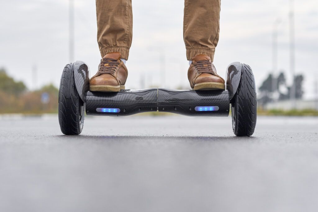 close-up-man-using-hoverboard-asphalt-road-1024x684.jpg