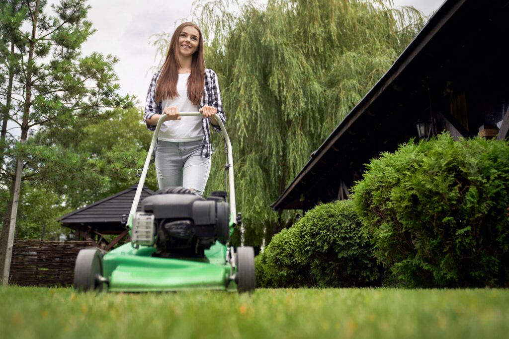 young-female-gardener-using-lawn-mower-1024x683.jpg