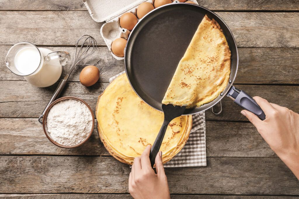 woman-making-thin-pancakes-frying-pan-kitchen-1024x683.jpg