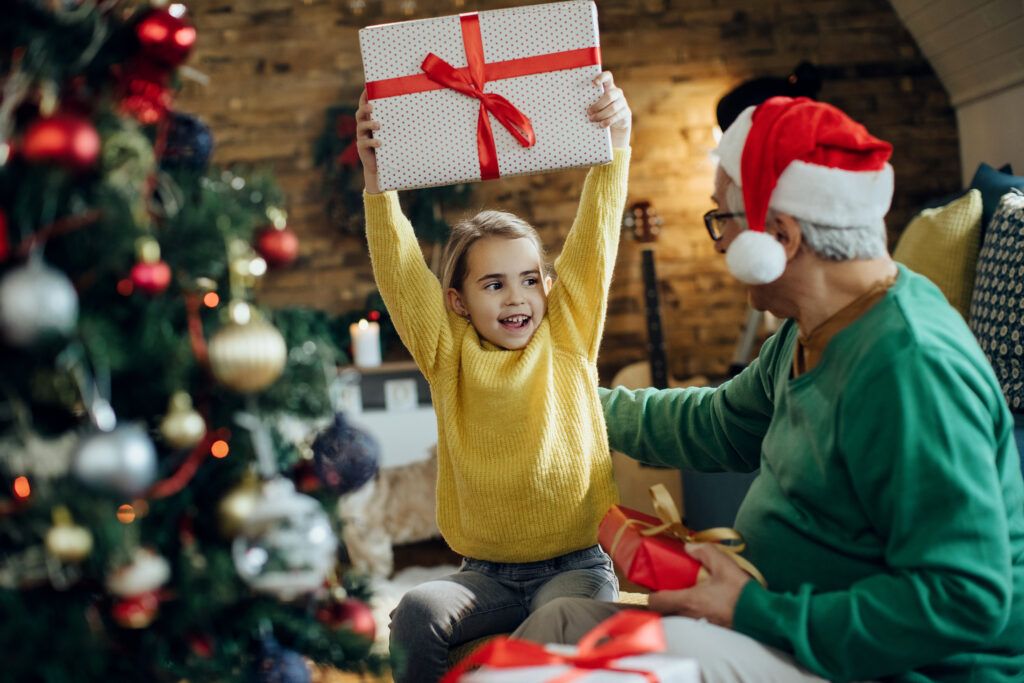 joyful-little-girl-having-fun-christmas-while-receiving-present-from-grandfather-1024x683.jpg