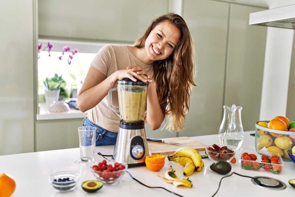 young-beautiful-hispanic-woman-preparing-vegetable-smoothie-with-blender-kitchen-1024x683.jpg