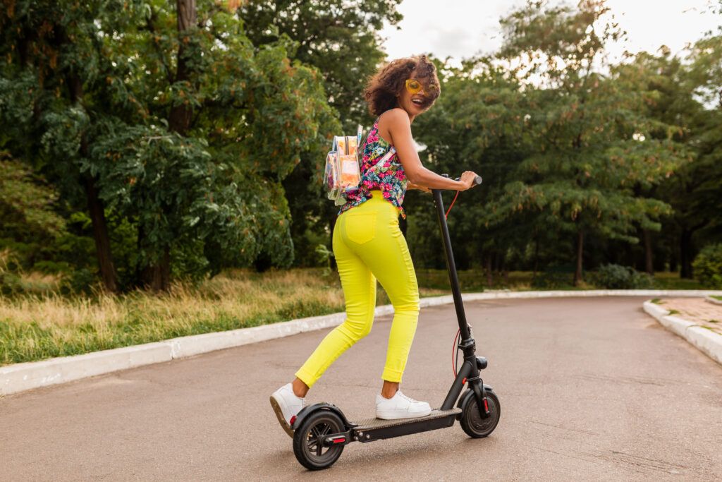 young-stylish-black-woman-having-fun-park-riding-electric-kick-scooter-summer-fashion-style-colorful-hipster-outfit-wearing-backpack-yellow-sunglasses-1024x683.jpg