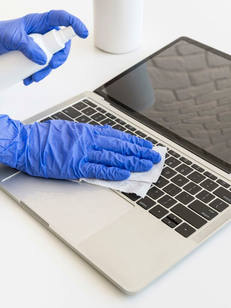 person-disinfecting-laptop-768x1024.jpg