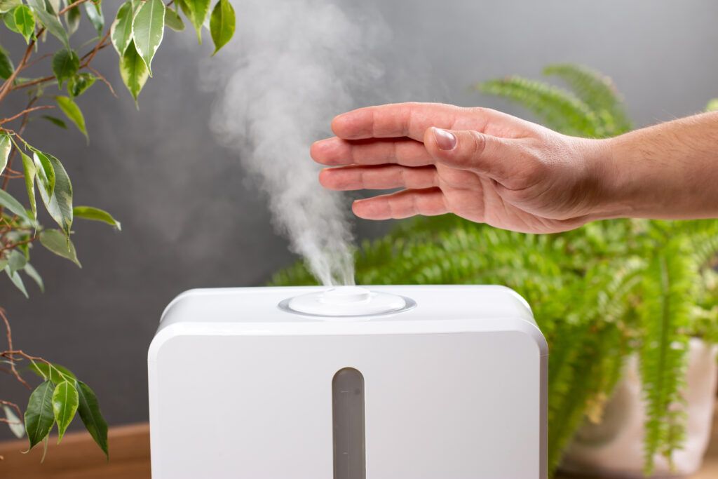 man-holds-hand-steam-aroma-oil-diffuser-home-1024x683.jpg