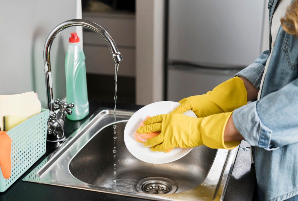 side-view-woman-washing-plate-sink-1024x689.jpg
