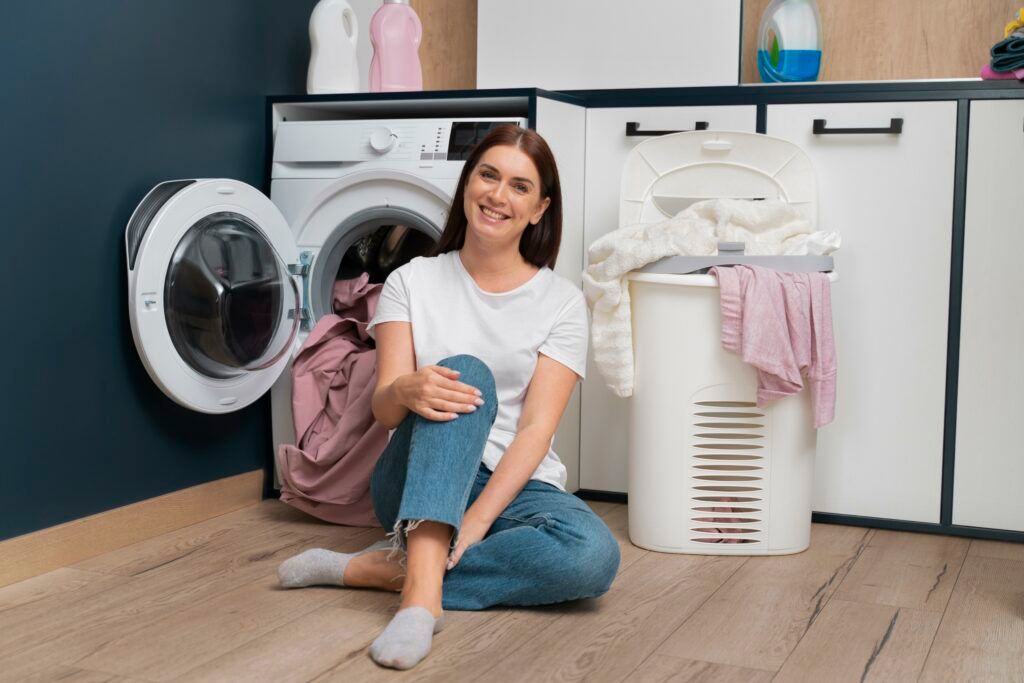 woman-sitting-washing-machine-with-basket-full-clothes-1024x683.jpg
