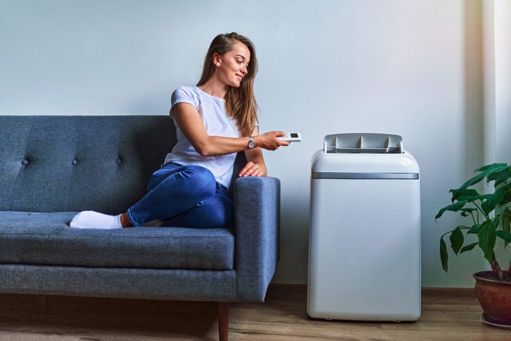 young-casual-woman-sitting-sofa-using-floor-air-conditioner-cooling-hot-summer-weather-fresh-clean-air-home-1024x683.jpg