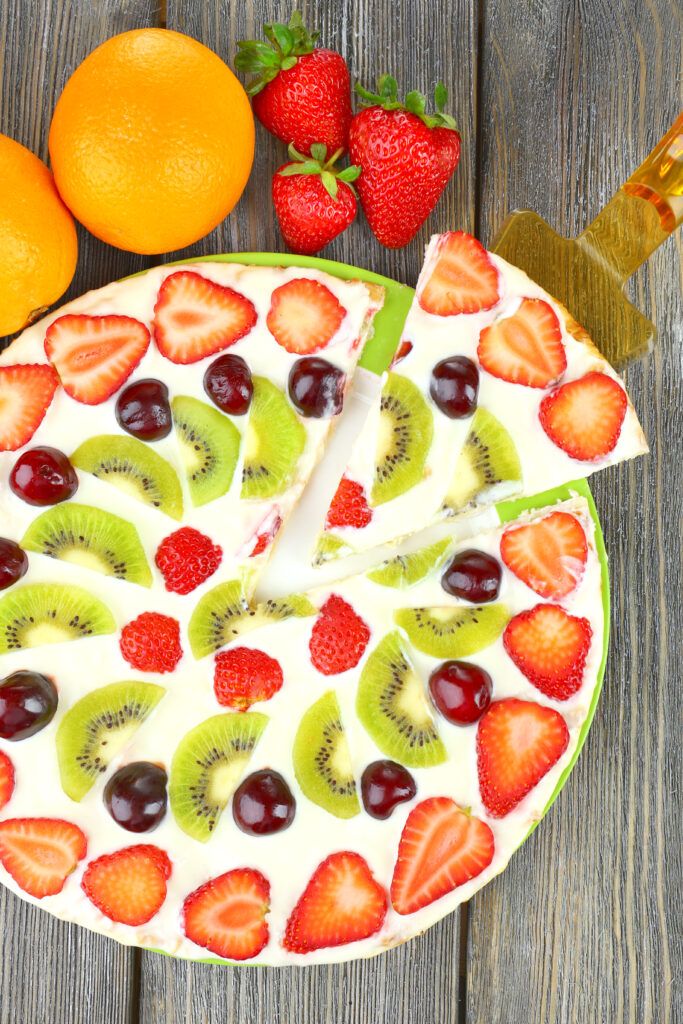 homemade-sweet-pizza-with-fruits-wooden-table-close-up-683x1024.jpg