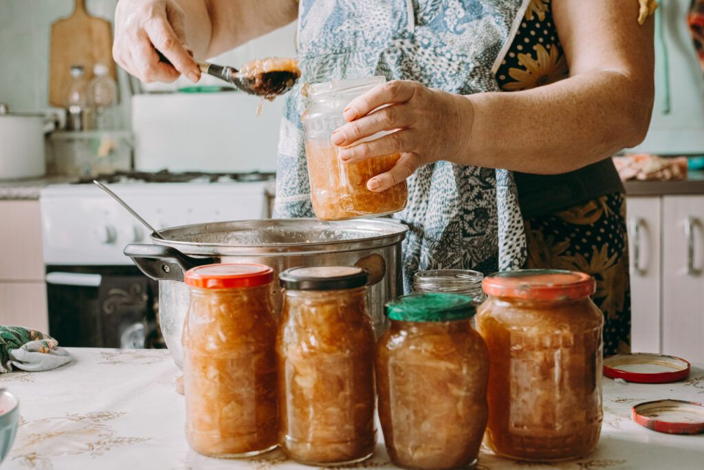 elderly-woman-puts-jam-jar-preservation-red-ripe-apples-table-jam-pot-1024x683.jpg