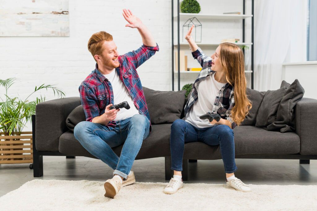 young-couple-giving-high-five-while-playing-video-game-living-room-1-1024x683.jpg